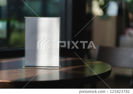 Stand Mock up Menu frame tent card blurred background design key visual layout A modern acrylic stand on the counter displays 125823782