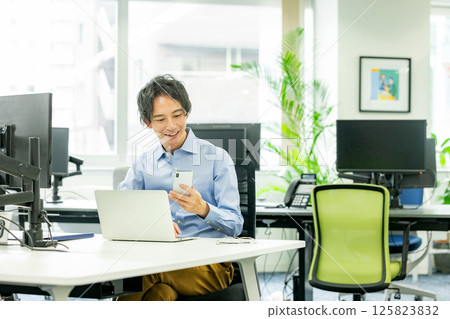 Engineer working in office, smartphone Engineer working in office, smartphone 125823832
