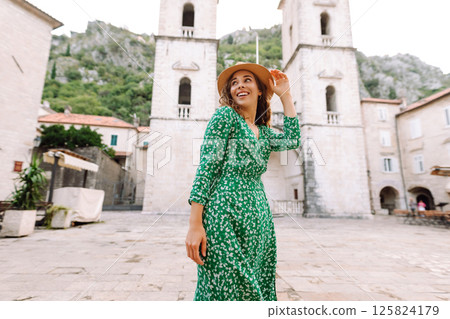 Happy female tourist in beautiful dress walking in the street of the city. Fashion style. Travel. Happy female tourist in beautiful dress walking in the street of the city. Fashion style. Travel. 125824179