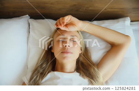 Exhausted tired woman suffering from headache, stress, fatigue, temples pain, migraine, loud noise 125824281