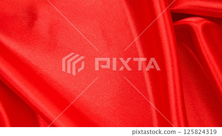 vibrant red satin fabric with smooth texture and elegant draping, showcasing rich folds and curves that create luxurious appearance. soft lighting enhances its beauty and depth vibrant red satin fabric with smooth texture and elegant draping, showcasing rich folds and curves that create luxurious appearance. soft lighting enhances its beauty and depth 125824319