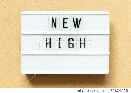 Lightbox with word new high on wood background Lightbox with word new high on wood background 125824458