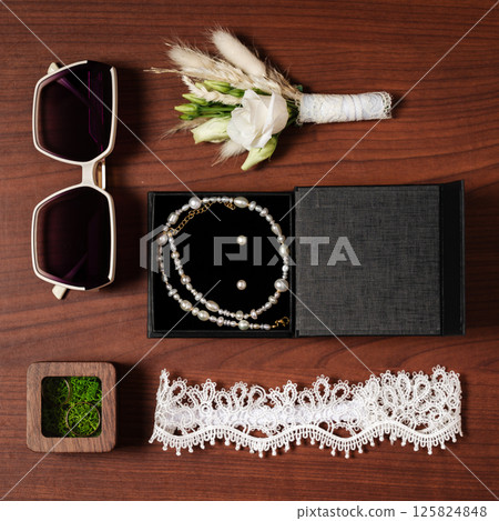 Bridal accessories: jewelry, flowers, sunglasses, garter. 125824848