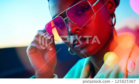 Y2K fashion portrait of woman in pink-tinted futuristic sunglasses with vibrant colors 125825367