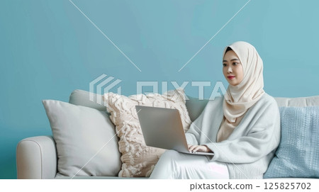 Young hijab female checking laptop casual style at home 125825702