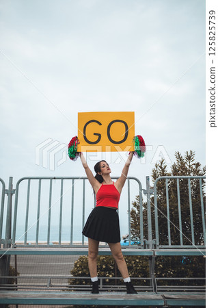 Cheerleader Girl Cheers Her Heart Basketball Team On The Stands 125825739