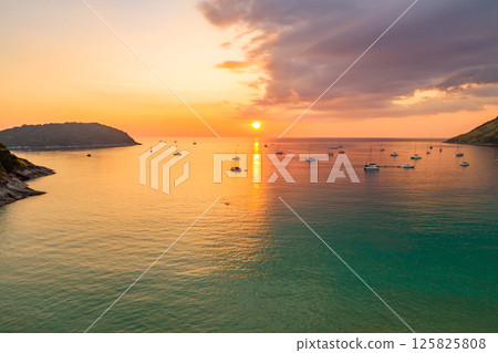 Nature beautiful light sunset or sunrise over sea surface,Colorful sunset sky with clouds and waves in the ocean,Wide angle sea background 125825808