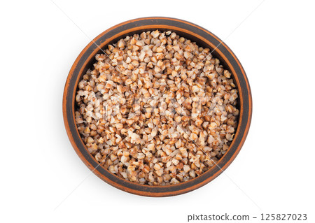 Boiled buckwheat in a ceramic bowl isolated on white background. Top view. Flat lay 125827023