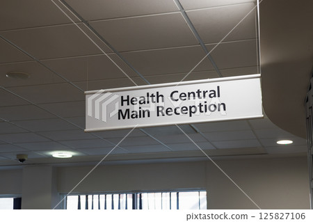 Health Central main reception sign hanging in modern healthcare facility corridor 125827106