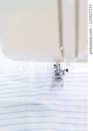 sewing machine with a cloth under a steel needle. manufacture of clothing. sewing machine with a cloth under a steel needle. manufacture of clothing. 125827313