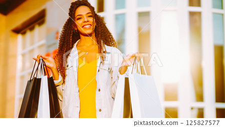 Young woman with shopping bags walking on street. , Sale concept. Young woman with shopping bags walking on street. , Sale concept. 125827577