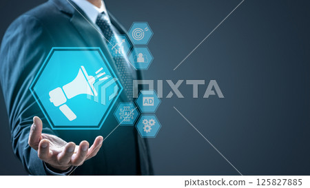 Businessman is showing an icon of a megaphone and a scheme icon of ads in his hand. Technology innovation on a virtual screen. Concept of Advertising and Marketing Plan Strategies Businessman is showing an icon of a megaphone and a scheme icon of ads in his hand. Technology innovation on a virtual screen. Concept of Advertising and Marketing Plan Strategies 125827885