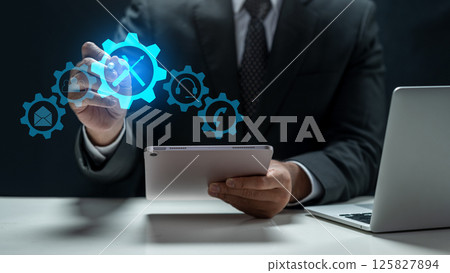 Businessman with tablet touching the icon of wrench and screwdriver tools. Technology innovation on a virtual screen. Concept of technical support or customer service 125827894