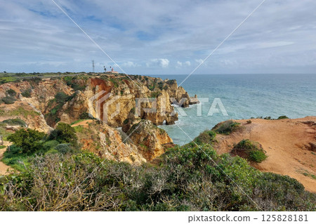 Picturesque Seaside Cliffs and Coastal Landscape Under Cloudy Sky 125828181
