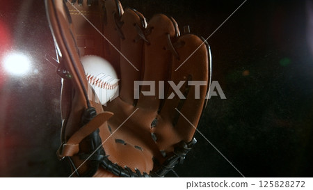 Hand in brown leather baseball glove caught ball isolated on black background 125828272