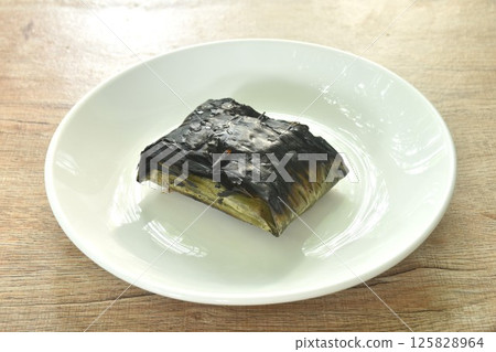 grilled chop pork curry in banana leave Thai northern food on plate 125828964