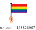 Hand holds vibrant rainbow flag symbolizing LGBTQ+ pride and diversity 125828967