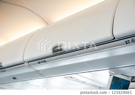 Luggage compartment inside passenger aircraft 125829061
