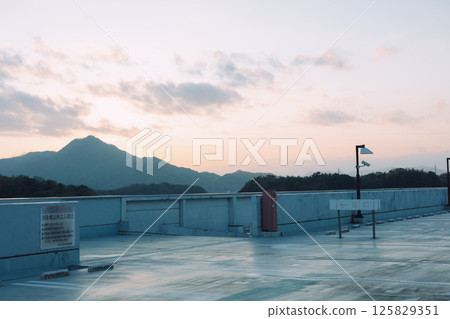 A rooftop bathed in a pink sunset 125829351