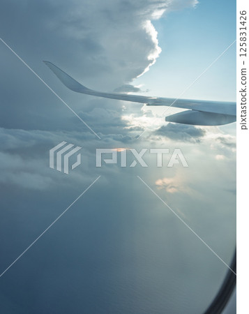 Light on the clouds outside the airplane window Light on the clouds outside the airplane window 125831426