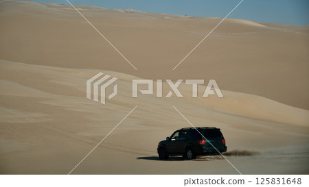 Car speeding in a desert 125831648
