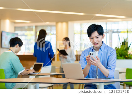 Young engineers working in an office. Photo courtesy of Denpa Gakuen, Tokyo Electronics College. Young engineers working in an office. Photo courtesy of Denpa Gakuen, Tokyo Electronics College. 125831738
