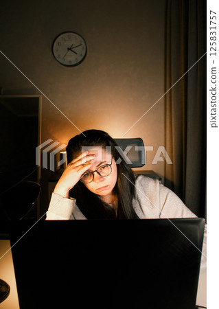 Tired woman working on computer touching her head because of headache. Office worker with migraine. Stressed overworked employee suffering from pain on workplace. 125831757