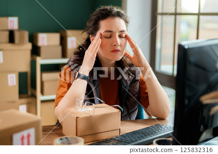Woman working in a warehouse. 125832316
