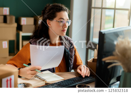 Woman working in a warehouse 125832318