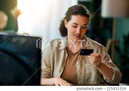 Woman is doing online purchases 125832324