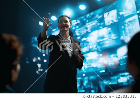 A woman is speaking on stage A woman is speaking on stage 125833313