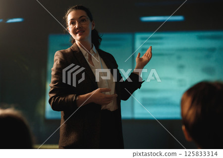 A woman is speaking on stage A woman is speaking on stage 125833314