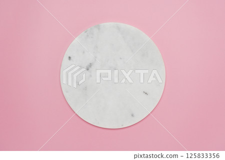 Round marble podium on baby pink background top view Round marble podium on baby pink background top view 125833356