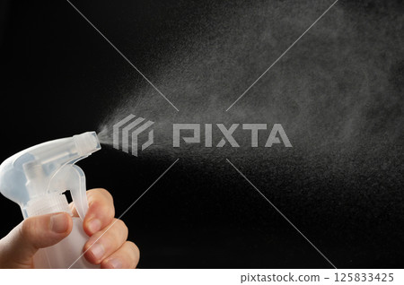 Cleaning surface with water spray 125833425