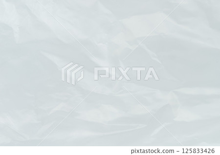 Wrinkled plastic with light gray hues and subtle tone variations 125833426