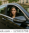 A woman looking out of the window of a car 125833798