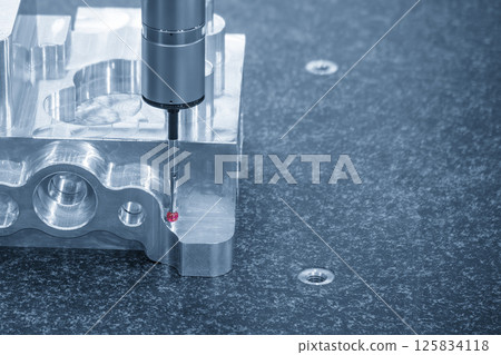The CMM machine measuring the aluminum parts in the light blue scene. 125834118
