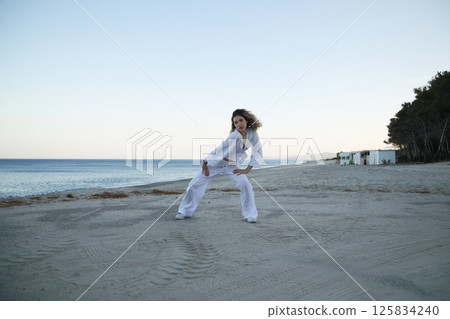 Summer Evening Dance on Shoreline by Girl in White Dress 125834240