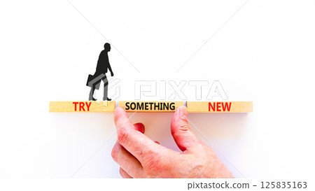 Try something new symbol. Concept words Try something new on beautiful block. Businessman's hand. Beautiful white background. Business motivational lifestyle try something new concept. Copy space. 125835163