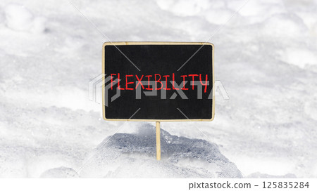 Flexibility symbol. Concept word Flexibility on beautiful chalk blackboard. Beautiful white snow background. White snow. Business flexibility concept. Copy space. Flexibility symbol. Concept word Flexibility on beautiful chalk blackboard. Beautiful white snow background. White snow. Business flexibility concept. Copy space. 125835284