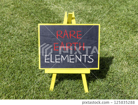 Rare earth elements symbol. Concept words Rare earth elements on beautiful yellow blackboard. Beautiful green grass lawn background. Business and rare earth elements concept. Copy space. 125835288