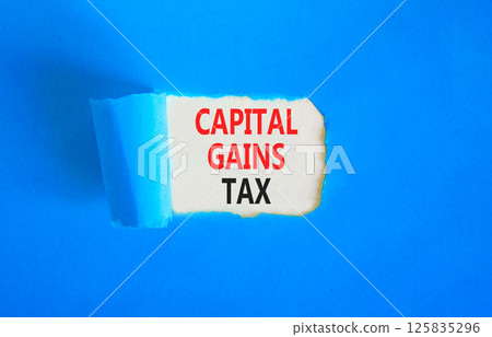Capital gains tax symbol. Concept words Capital gains tax on beautiful white paper. Beautiful blue paper background. Business and capital gains tax concept. Copy space. Capital gains tax symbol. Concept words Capital gains tax on beautiful white paper. Beautiful blue paper background. Business and capital gains tax concept. Copy space. 125835296