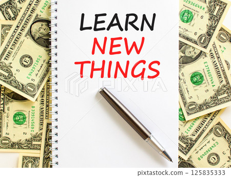 Learn new things symbol. Concept words Learn new things on beautiful white note. Beautiful background from dollar bills. Black pen. Business motivational learn new things concept. Copy space. 125835333