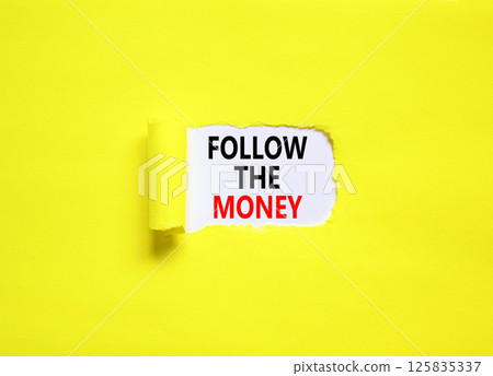 Follow the money symbol. Concept words Follow the money on beautiful white paper. Beautiful yellow paper background. Business and follow the money concept. Copy space. Follow the money symbol. Concept words Follow the money on beautiful white paper. Beautiful yellow paper background. Business and follow the money concept. Copy space. 125835337
