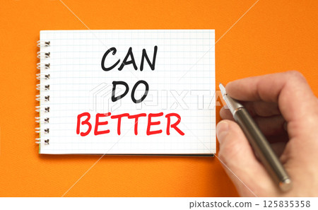 Can do better symbol. Concept words Can do better on beautiful white note. Beautiful orange background. Businessman hand with pen. Business and can do better concept. Copy space. Can do better symbol. Concept words Can do better on beautiful white note. Beautiful orange background. Businessman hand with pen. Business and can do better concept. Copy space. 125835358