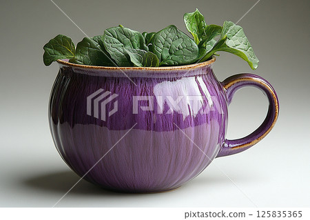 Ceramic cup in shape of a purple eggplant in a rustic style on a white background. 125835365