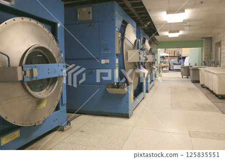 Row of textile dyeing machines. 125835551