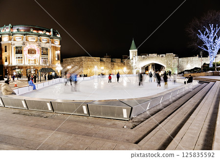 Night ice skating scene from Place d'Youville quebec Night ice skating scene from Place d'Youville quebec 125835592