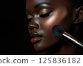 African female model with radiant makeup highlighting cheekbones 125836182