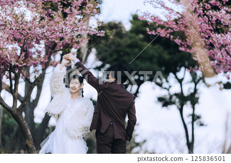 A young couple taking pre-wedding photos at Jogashima 125836501